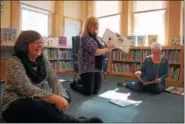  ?? LISA MITCHELL - DIGITAL FIRST MEDIA ?? District Justice Judge Gail Greth, center, reads during Fleetwood Public Library Girl Power Story Hour. Also reading empowering girl stories were Pastor Sara Hertzog and Fleetwood Mayor Tammy Gore.