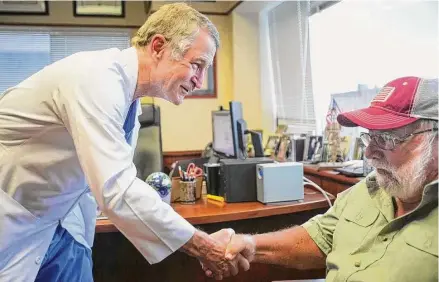  ?? Brett Coomer/Staff photograph­er ?? Reardon talks to a 71-year-old patient from Louisiana, Jesse Shinault, in his office at Houston Methodist Hospital last August.
