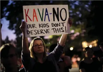  ?? (Reuters) ?? A WOMAN protests against Brett Kavanaugh.