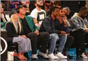  ?? MIKE LAWRIE / GETTY IMAGES ?? Masters champion Patrick Reed, with wife Justine (left) and comedian Chris Rock along with other celebritie­s, wears his green jacket to the Knicks-Cavs game Monday at Madison Square Garden.