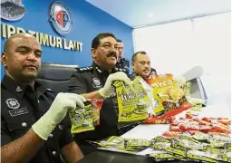  ??  ?? No ordinary cuppa: ACP Anuar (second left) with his officers showing the tampered premix coffee packets at the district police station.