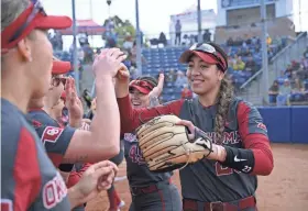  ?? ORLANDO RAMIREZ/USA TODAY SPORTS ?? OU second baseman Tiare Jennings (23) celebrates with teammates on Feb. 12 when the Sooners beat San Jose State 9-0.