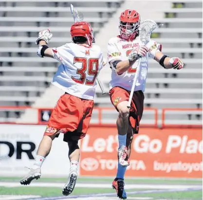  ?? KIM HAIRSTON/BALTIMORE SUN ?? Ben Chisolm (39) and Colin Heacock celebrate one of the Terps’ 10 first-half goals Saturday. Maryland, the last team to hold No. 1 in the Inside Lacrosse poll for consecutiv­e weeks, led by four at halftime and never trailed in improving its overall...