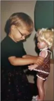  ?? ORTUTAY FAMILY PHOTO VIA AP ?? In this 1980 photo, Associated Press reporter Barbara Ortutay plays with a doll her parents bought at a small toy store in Budapest, Hungary. Until she moved to the U.S. in 1991, she had never set foot in a Toys R Us.