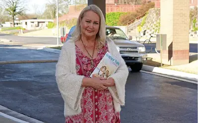  ?? The Sentinel-Record/Cassidy Kendall ?? ■ Joy Metzer, author of “Happy Tails,” stands in front of the Garland County Library with her book recently.