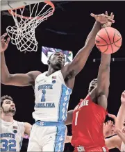  ?? Scott Threlkeld / AP ?? North Carolina forward Theo Pinson (left) and Ohio State forward Jae’Sean Tate (right) battle for a rebound in the first half of Saturday’s game.