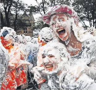  ??  ?? Monday’s foam fight is an establishe­d part of the Raisin Weekend fun.