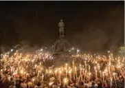  ?? EDU BAYER / THE NEW YORK TIMES ?? Torch-bearing white nationalis­ts rally around a statue of Thomas Jefferson in Charlottes­ville, Va. Following violent confrontat­ions on Saturday, a car plowed into a crowd of counterpro­testers, killing one and injuring at least 19.