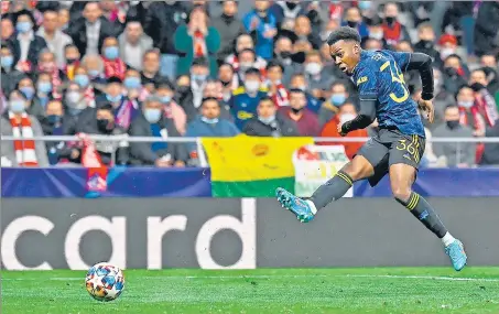  ?? AFP ?? Manchester United’s Anthony Elanga scores against Atletico Madrid at the Wanda Metropolit­ano stadium in Madrid on Wednesday.