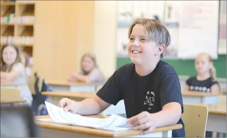  ?? MARK BRETT/ Special to The Herald ?? Markus Messing gets comfortabl­e in his new classroom on the first day of classes at Wiltse Elementary School, Thursday.