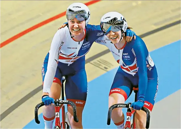  ??  ?? United in victory: All smiles from Great Britain’s Katie Archibald (left) and Emily Nelson as they celebrate winning gold medals in the Madison at the Track World Championsh­ips in Holland last night