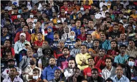  ?? Photograph: Marko Đurica/Reuters ?? At a fan zone in a cricket stadium on the edge of Doha, migrant workers watch the first match of the 2022 World Cup – Qatar v Ecuador.