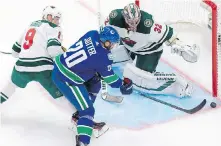  ??  ?? Canucks centre Brandon Sutter is thwarted by Wild goaltender Alex Stalock during the second period in Edmonton.