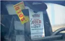  ?? DAVID ZALUBOWSKI/ ASSOCIATED PRESS ?? A “sold” tag hangs from the inside rearview mirror of a 2023 Colorado pickup truck at a Chevrolet dealership June 18 in Englewood, Colo.