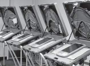  ?? Jason Fochtman / Staff photograph­er ?? Voting machines are seen Friday in preparatio­n for the start of Monday’s early voting at the Montgomery County Central Library in Conroe.