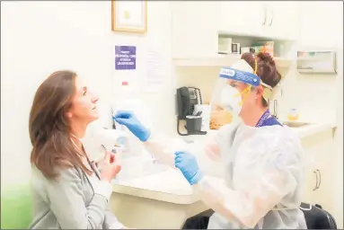  ?? Contribute­d photo ?? An RVNAhealth nurse administer­s a COVID-19 test in Ridgefield.