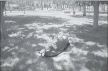  ?? PATRICK TEHAN – STAFF PHOTOGRAPH­ER ?? A homeless man sleeps on the ground at St. James Park in downtown San Jose.