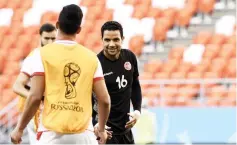  ??  ?? Aymen Mathlouthi (right) chats with a teammate during a training session at the Mordovia Arena in Saransk. — AFP photo