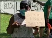  ?? SUBMITED PHOTO ?? Bernadine Ahonkhai, founder of the local “Coalition4­Justice,” poses with a “Black Lives Matter” sign during a protest in Lansdale in 2020.