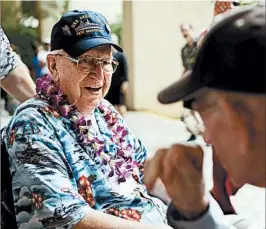  ?? KENT NISHIMURA/FOR LOS ANGELES TIMES ?? USS Arizona survivor Lauren Bruner talks with Pearl Harbor survivor Brian Welch during a meet and greet event Sunday.