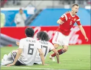  ?? EFREM LUKATSKY — THE ASSOCIATED PRESS ?? Russia’s Denis Cheryshev, right, celebrates after scoring his team’s second goal Tuesday. Russia is 2-0in group play.
