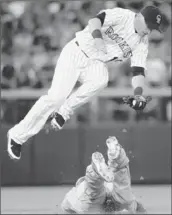  ?? Doug Pensinger Getty Images ?? TONY GWYNN JR. steals second in the fifth inning as Colorado’s Marco Scutaro jumps for the throw.