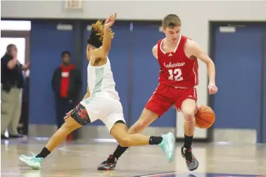  ?? STAFF PHOTO BY OLIVIA ROSS ?? LFO's Brent Bowman (12) dribbles behind his back to avoid a defender. Bowman, who has more than 1,600 career points, will lead the Warriors into Tuesday's state tournament game against Douglass.