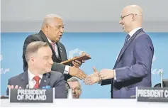  ?? — Reuters photo ?? Fiji Prime Minister and COP 23 president Frank Bainimaram­a (left) talks with the president of COP 24 Michal Kurtyka as Polish President Andrzej Duda looks on during the opening of COP24 UN Climate Change Conference 2018 in Katowice.