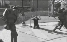  ?? HELEN H. RICHARDSON/THE DENVER POST VIA AP ?? A MAN IS TAKEN INTO CUSTODY after fatally shooting another man Oct. 10 in Denver. At the time two rallies, one right-wing and one left-wing, were taking place near one another.