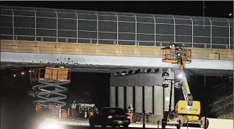  ?? MARSHALL GORBY / STAFF ?? Workers do repair work on the Smithville Road Bridge over U.S. 35 Sunday night.