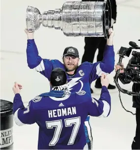  ?? GERRY BROOME THE ASSOCIATED PRESS FILE PHOTO ?? Tampa Bay Lightning captain Steven Stamkos hands the Stanley Cup to Victor Hedman. Having won back-to-back titles, no team knows better than the Lightning the breaks it takes to win it all.