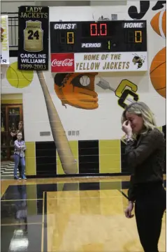  ?? Kevin Myrick / SJ ?? Caroline Williams Hipps wipes away tears after seeing a banner retiring her number unfurled during a celebratio­n between games on Friday night, Feb. 2.