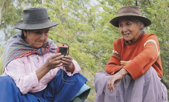  ??  ?? Women in Peru listen to the gospel on a solar-powered, fix-tuned radio and audio Bible from Galcom Internatio­nal – made by volunteers in Canada.