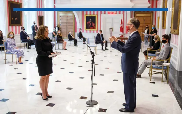  ?? Adam Scotti photo ?? Chrystia Freeland is sworn in as Finance Minister at Rideau Hall. Also at the socially-distanced ceremony, Sophie Grégoire Trudeau (left), Intergover­nmental Affairs Minister Dominic Leblanc (centre) and along the wall, Governor General Julie Payette and Prime Minister Justin Trudeau.