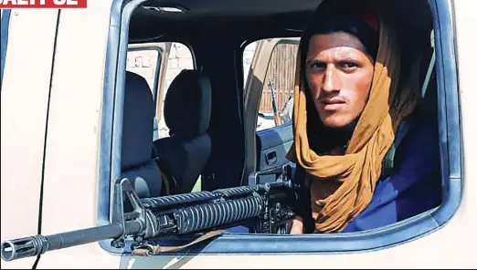  ??  ?? Seized: A Taliban fighter points his rifle from an Afghan National Army vehicle in Laghman province yesterday