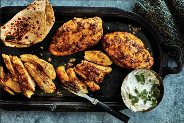  ?? (The New York Times/Romulo Yanes) ?? Priya Krishna’s Garlic-Ginger Chicken Breasts With Cilantro and Mint