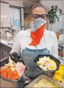  ?? La Strega ?? A worker at La Strega wears a face covering while handling food.