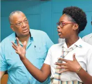  ??  ?? Aliyah Rhodd, a sixth-form student at Camperdown High School, in an animated discussion with Leader of the Opposition Dr Peter Phillips.