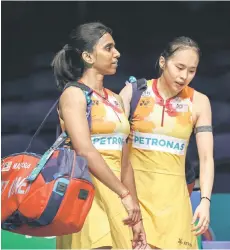 ?? Bernama file photo — ?? M Thinaah (left) and Pearly Tan react after a women’s doubles match.