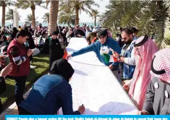  ??  ?? KUWAIT: People sign a banner urging HH the Amir Sheikh Sabah Al-Ahmad Al-Jaber Al-Sabah to cancel their loans during a gathering in Irada Square opposite the National Assembly yesterday. — Photo by Fouad Al-Shaikh (See Page 3)