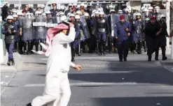  ??  ?? MANAMA: In this Jan 18, 2012 file photo, Hassan Al-Marzooq, deputy general secretary of the opposition National Democratic Assemblage society, runs across a street as riot police move in to disperse anti-government protesters. —AP