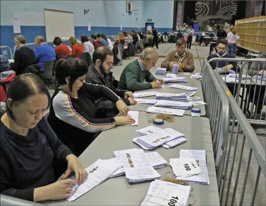  ??  ?? Counting the votes at the Wexford Count Centre in Coláiste Bríde in Enniscorth­y.