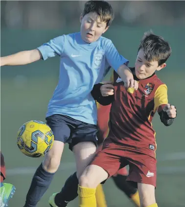  ??  ?? Durham United Pumas Under-10s (claret) in action against Washington AFC Wildcats.