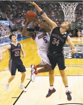  ?? Christian Petersen / Getty Images ?? Jock Landale of St. Mary’s tries to deny Arizona’s Kadeem Allen as the Wildcats worked inside to end the Gaels’ season in Salt Lake City.