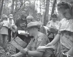  ??  ?? ABOVE: A park ranger leads a group of kids along a TRACK trail in North Carolina's Stone Mountain State Park. The trail is part of the Kids in Parks program, which encourages kids to explore nature.