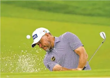  ?? JOHN RAOUX AP ?? Lee Westwood, hittiing from a sand trap on the second hole, had eight birdies and an eagle Saturday.