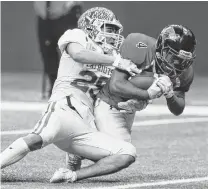  ??  ?? Wagner’s Karlton Black fights his way to the end zone for one of his three touchdowns. He had 160 yards on just nine carries.