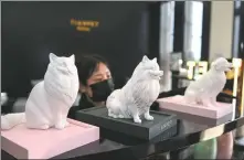  ?? YANG HUAFENG / CHINA NEWS SERVICE ?? Statues of pets made from their ashes and plaster are displayed at a pet funeral center in Changsha, Hunan province, in April 2022.