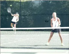  ?? Photos by ALEX FARRER / staff ?? ( Calhoun’s Neeley Abernathy (left) serves while her No. 2 doubles teammate Sammy Bramlett waits at the net. ( Calhoun’s Carly Briggs follows through on her serve during her No. 2 singles match.