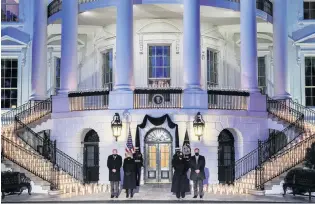  ?? PHOTO: REUTERS ?? Paying respects . . . US President Joe Biden, his wife Jill Biden, US Vicepresid­ent Kamala Harris and her husband Doug Emhoff attend a candleligh­ting ceremony at the White House in Washington yesterday to mark the fact there have been more than 500,000 US deaths from Covid19.